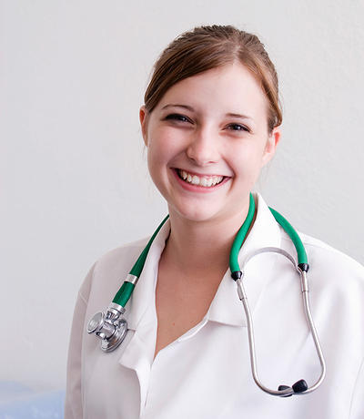 young female nurse smiling at the camera for employment opportunities page