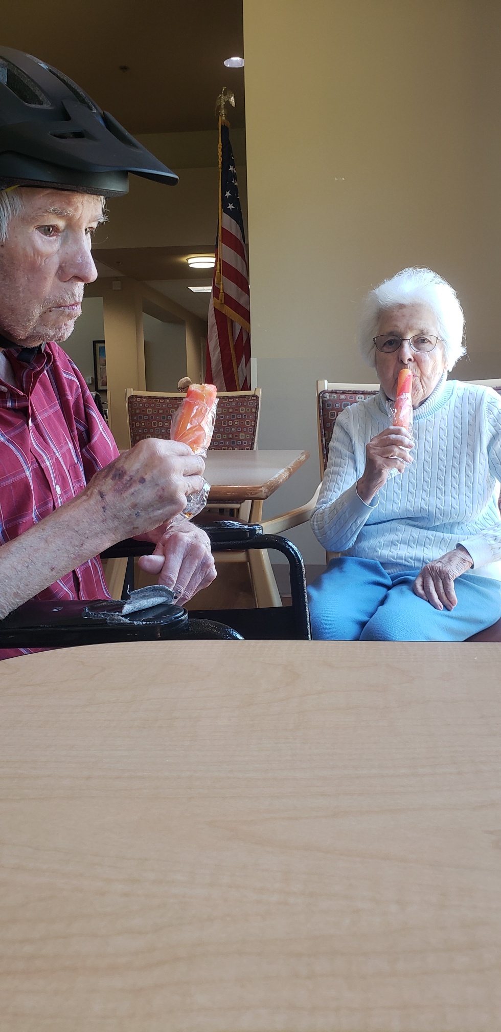 two elderly people having a popsicle in respite care